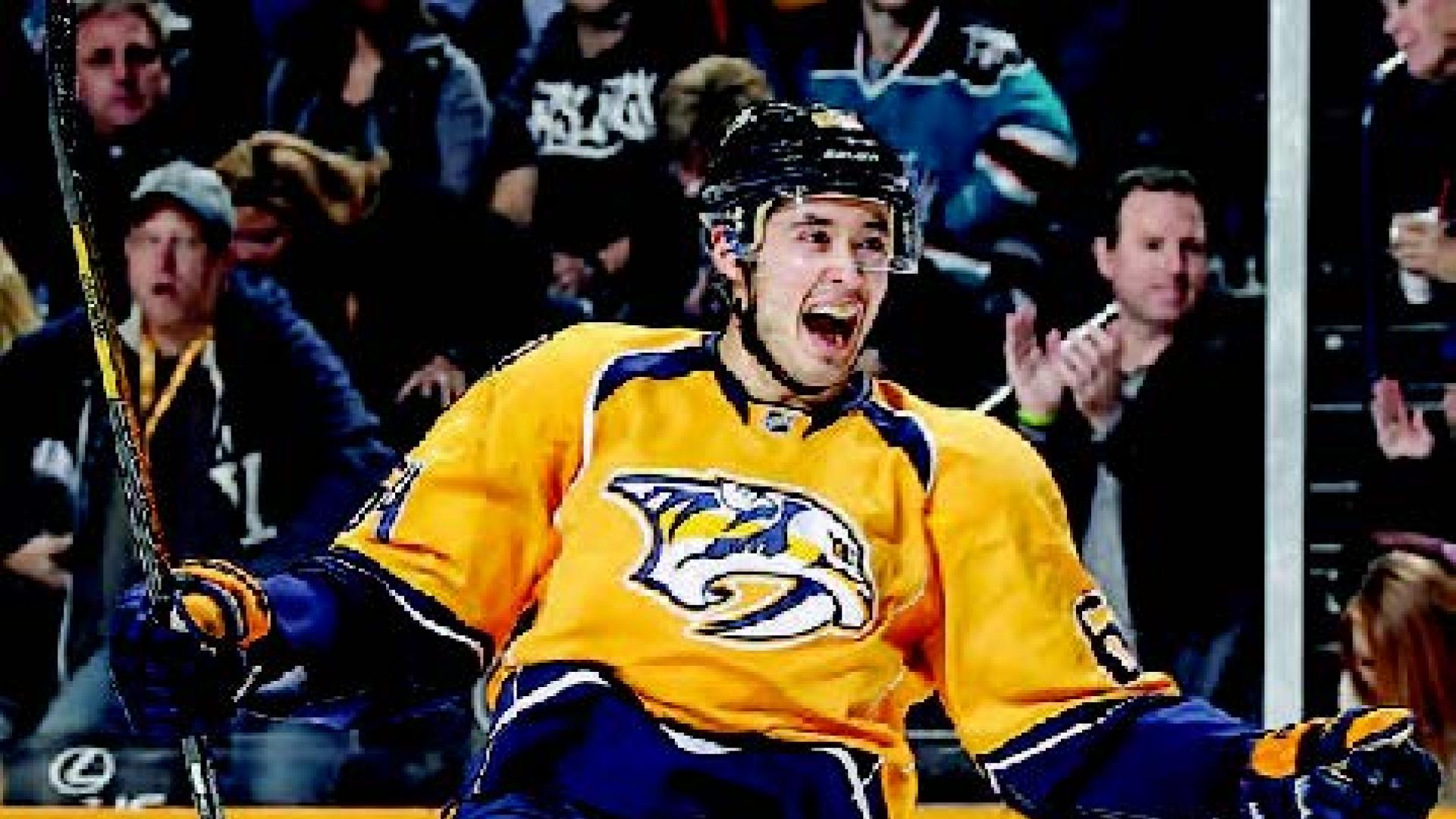 Victor Bartley leans back in joy as he skates across the hockey arena.
